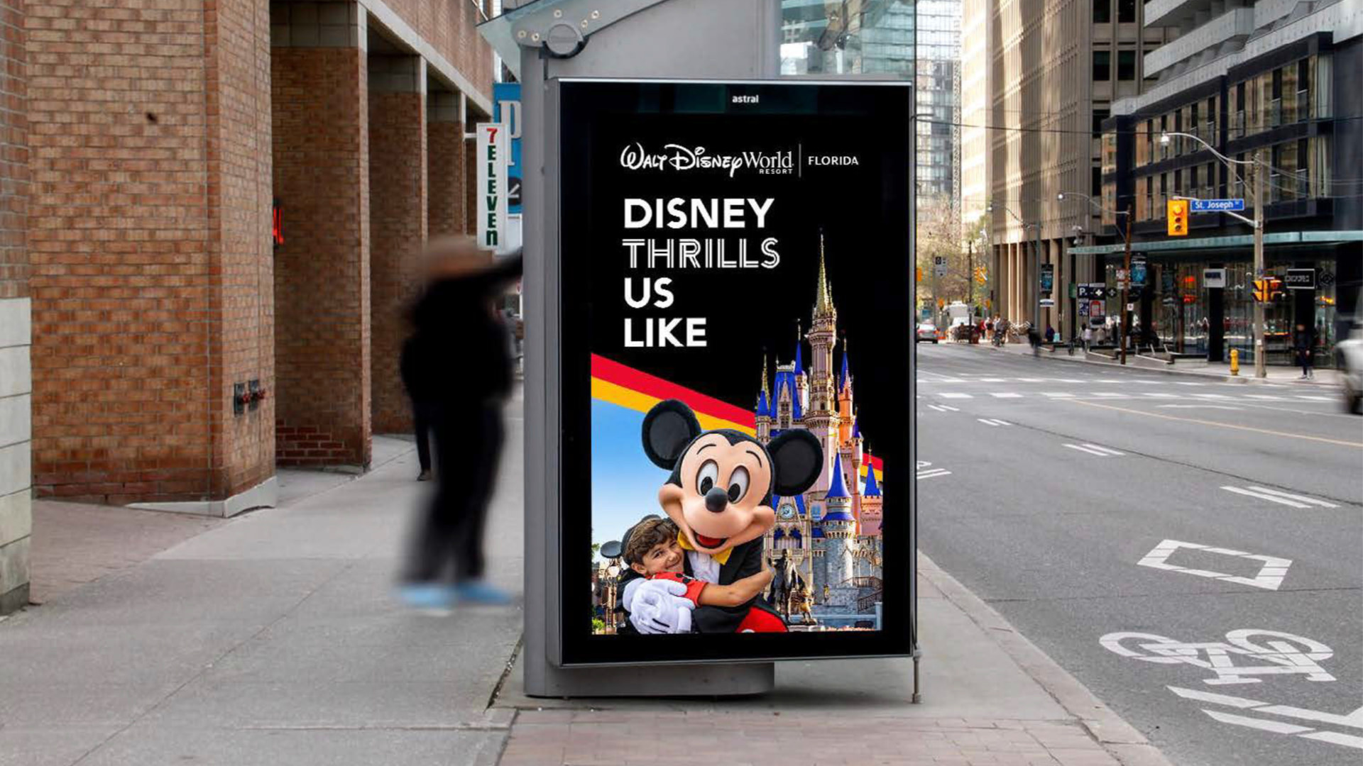 Disney Thrills bus shelter execution using the four-park color bar